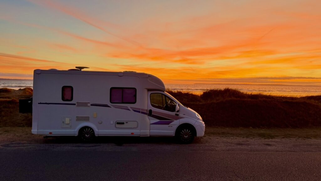 Our motorhome Benny parked behind the dunes at Pentrez-Plage at sunset, one of our free motorhome stops in Brittany