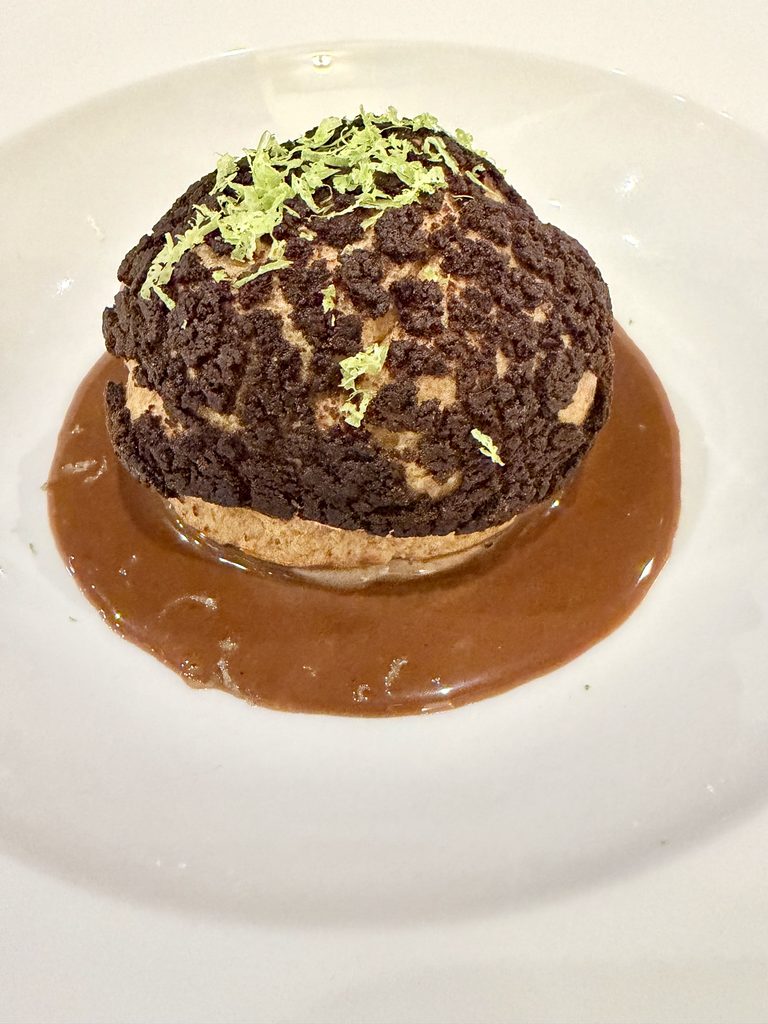 Cocoa choux bun with chocolate mousse and crumb, lime zest and chocolate treacle sauce